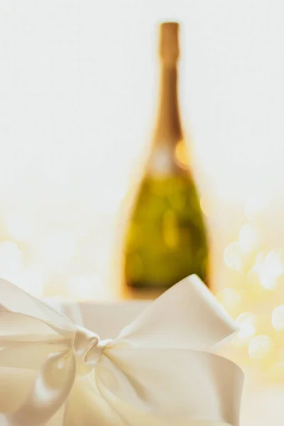 The bottle of champagne and holiday gift box — Stock Photo, Image