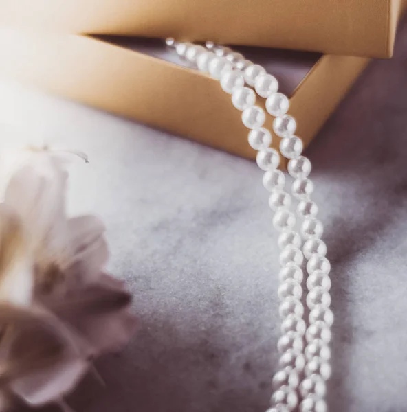 Pearl jewellery in a  golden gift box