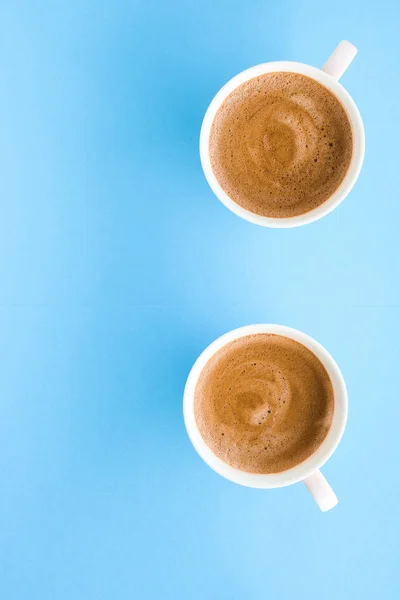 Hot aromatic coffee on blue background, flatlay