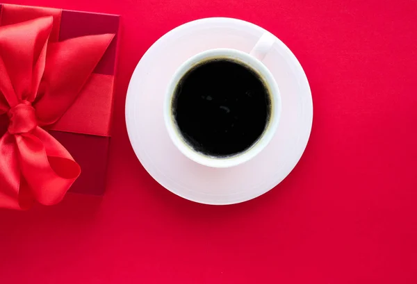 Luxury beauty gift box and coffee on red, flatlay