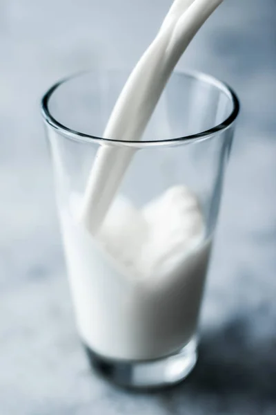 World Milk Day, pouring into glass on marble table