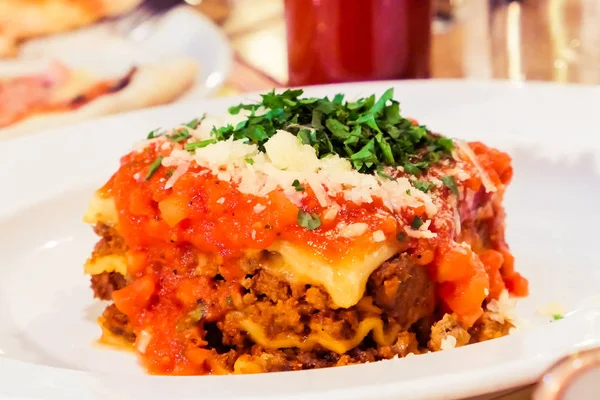 Lasagna bolognese plate, traditional recipe with tomato sauce, c