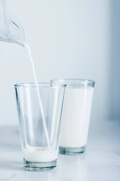 Stock image World Milk Day, pouring into glass on marble table