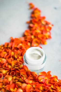 Mermer üzerinde güzellik yüz nemlendirici krem ve çiçek yaprakları, LuXu