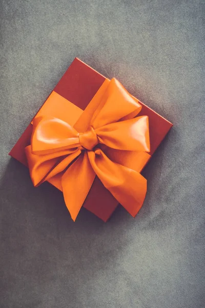 Vintage luxury holiday orange gift box with silk ribbon and bow,