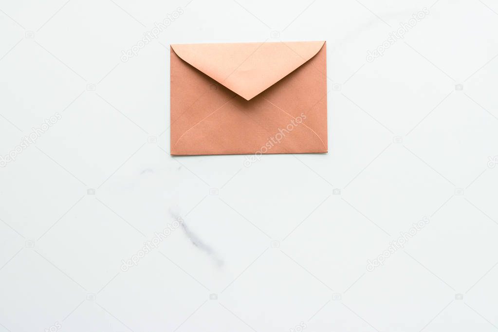 Blank paper envelopes on marble flatlay background, holiday mail