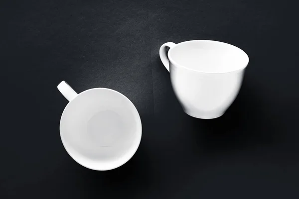 White tableware crockery set, empty cup on black flatlay backgro