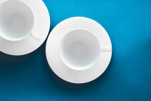 White tableware crockery set, empty cup on blue flatlay backgrou