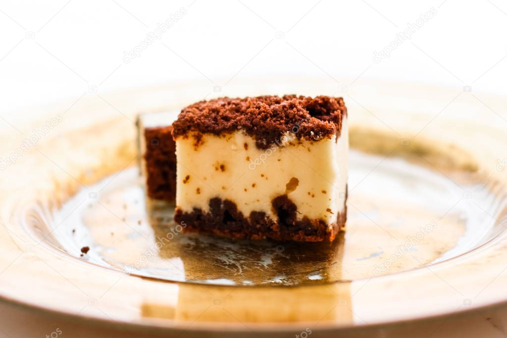 Classic cheesecake with chocolate on a golden plate, european cu