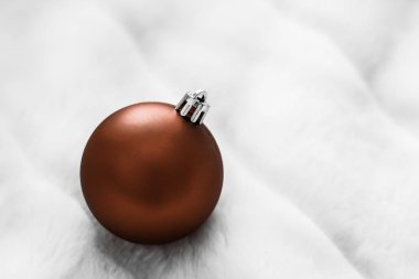 Beyaz kabarık kürk zemin üzerinde Çikolata kahverengi Noel baubles, 