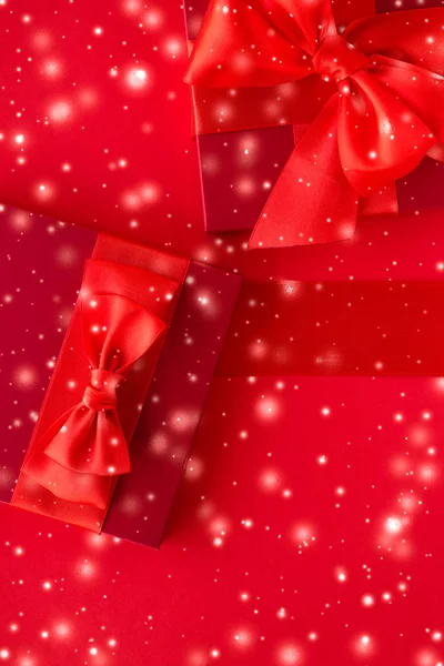 Χειμερινά δώρα διακοπών και λαμπερό χιόνι σε κόκκινο φόντο, Χριστίμ — Φωτογραφία Αρχείου