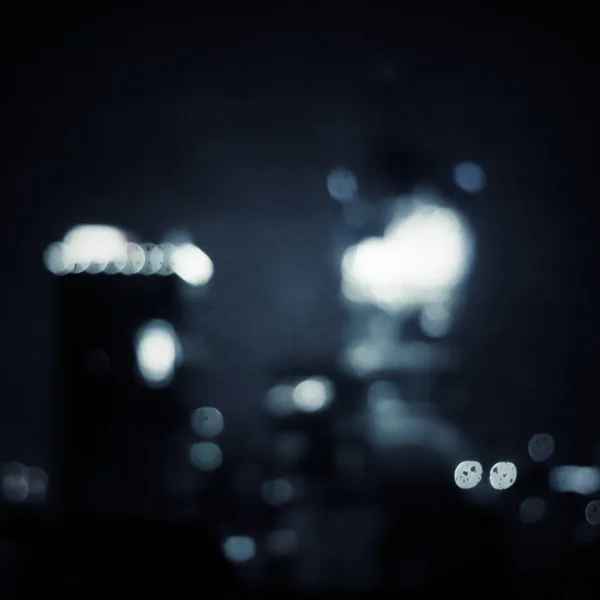 Big metropolitan city lights at night, blurry background — Stock Photo, Image