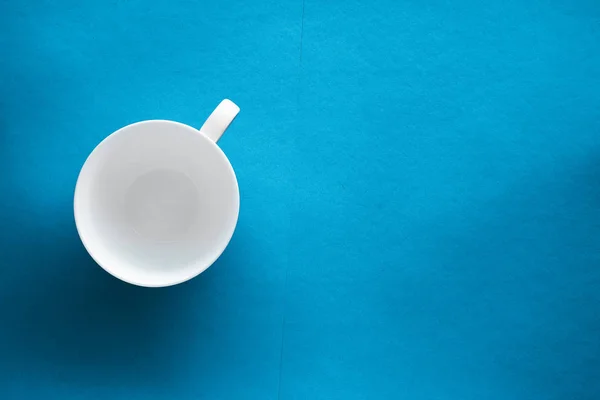 White tableware crockery set, empty cup on blue flatlay backgrou