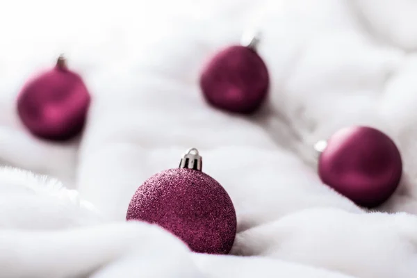 Purple Christmas baubles em fundo de pele macia branca, luxo wi — Fotografia de Stock