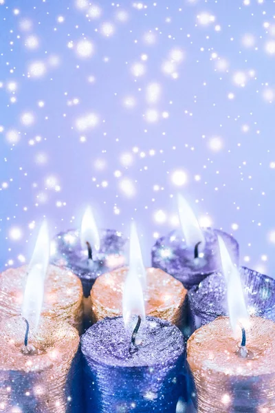 Kerst kaarsen en glanzende sneeuw op blauwe achtergrond, vakantie zee — Stockfoto