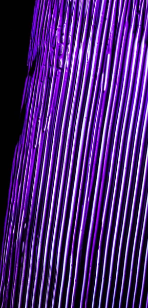 Purple neon paint brush stroke texture isolated on black backgro