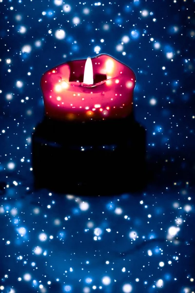 Червона святкова свічка на синьому ігристому сніжному фоні, розкіш — стокове фото