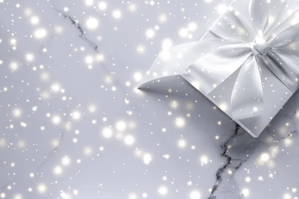 Luxury holiday gifts with white silk bow and ribbons on marble b