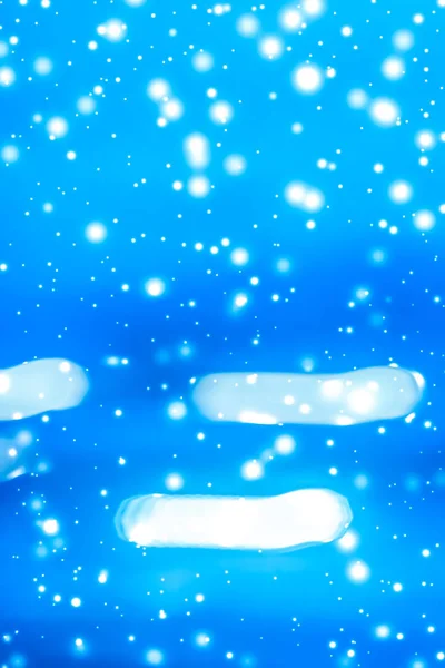 Winter holiday abstract background, glowing snow and magic spark