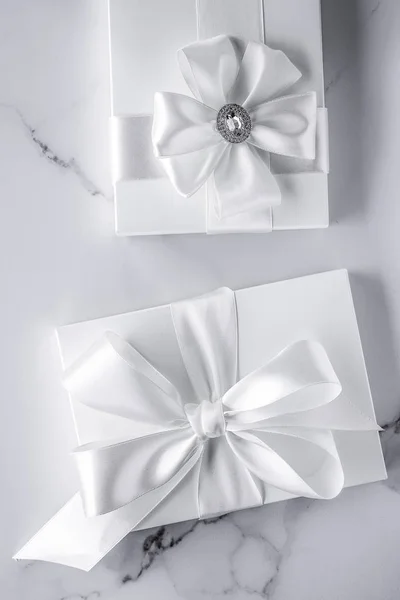 Luxury wedding gifts with silk bow and ribbons on marble backgro — Stock Photo, Image