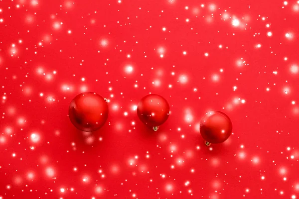 Christbaumkugeln auf rotem Hintergrund mit Schneeglitzern, Luxus — Stockfoto