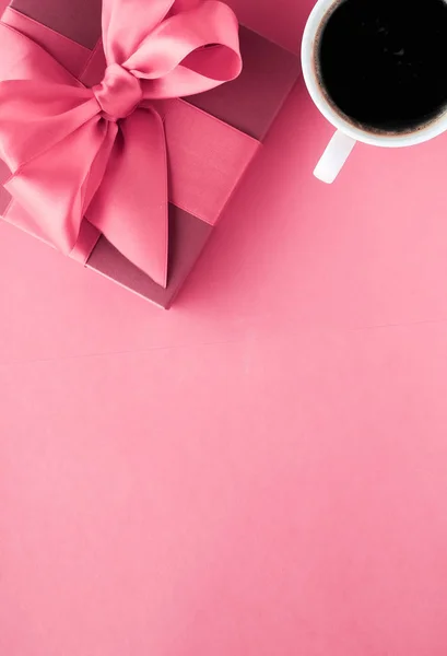 Luxury gift box and coffee cup on pink background, flatlay desig