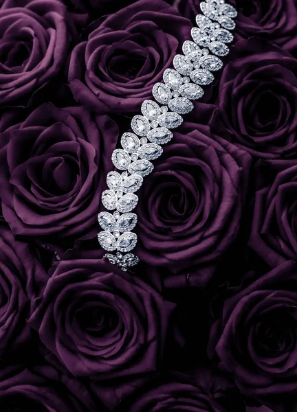 Luxury diamond jewelry bracelet and purple roses flowers, love g