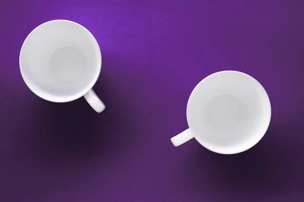 White tableware crockery set, empty cup on purple flatlay backgr