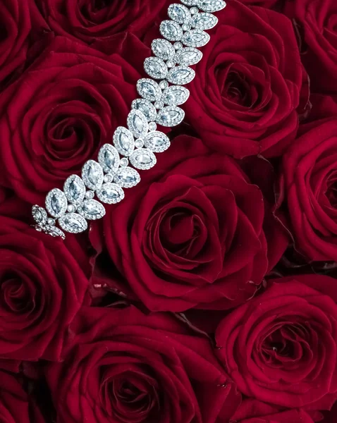 Luxury diamond jewelry bracelet and red roses flowers, love gift