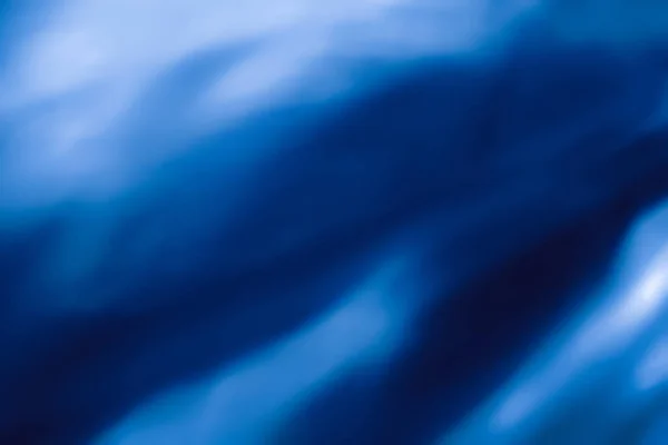 Синій абстрактний художній фон, шовкова текстура та хвильові лінії в моторі — стокове фото