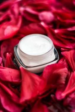 Kırmızı çiçek yaprakları ve WA Hassas Cilt Bakımı nemlendirici krem