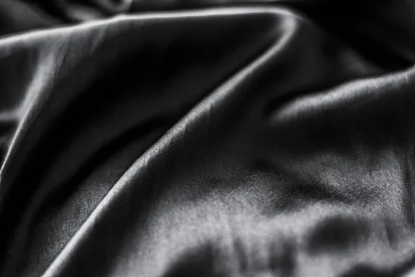 Роскошный черный мягкий шелк плоский фон текстуры, праздничный гламур — стоковое фото