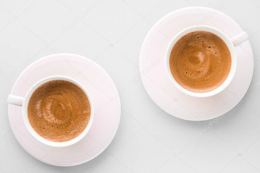 Cup of hot french coffee as breakfast drink, flatlay cups on whi