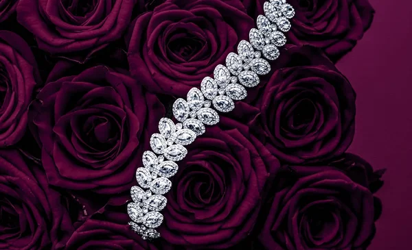 Luxury diamond jewelry bracelet and purple roses flowers, love g