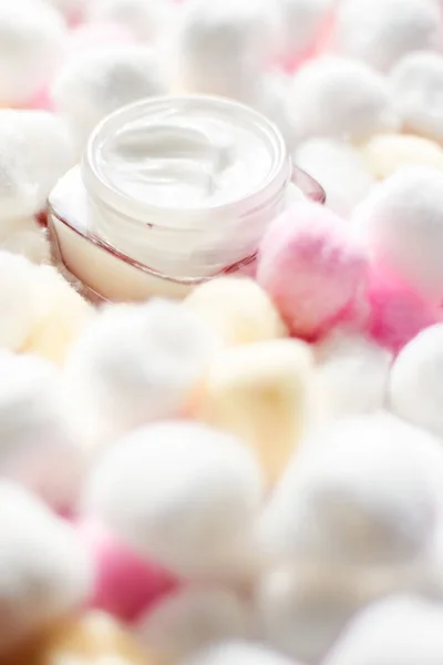 Luxury face cream for sensitive skin and eco cotton balls on bac