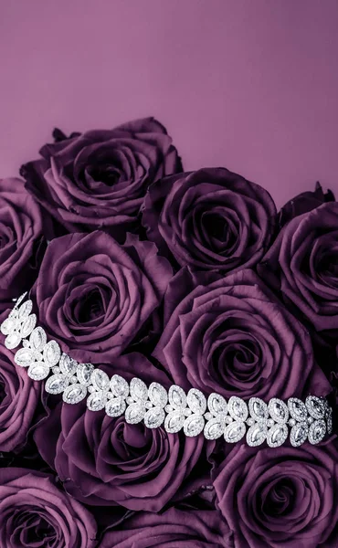 Luxury diamond jewelry bracelet and purple roses flowers, love g