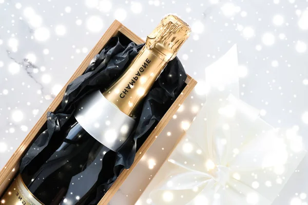 Bouteille de champagne de Noël et boîte cadeau et neige brillante — Photo