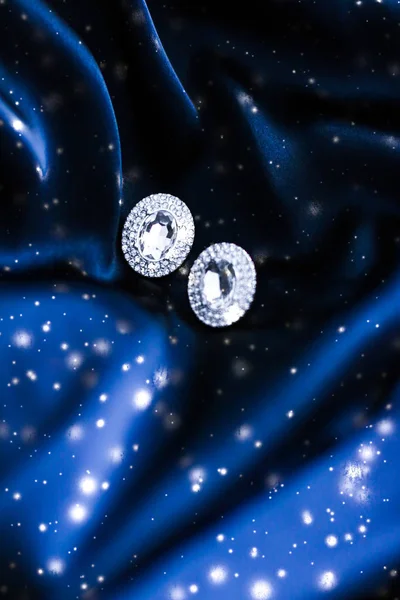 Boucles d'oreilles luxe en diamant sur soie bleu foncé avec paillettes de neige, hol — Photo