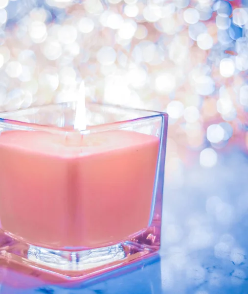 Coral aromatic candle on Christmas and New Years glitter backgro — Stock Photo, Image