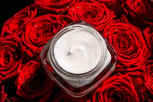 Moisturizing beauty face cream for sensitive skin and red roses