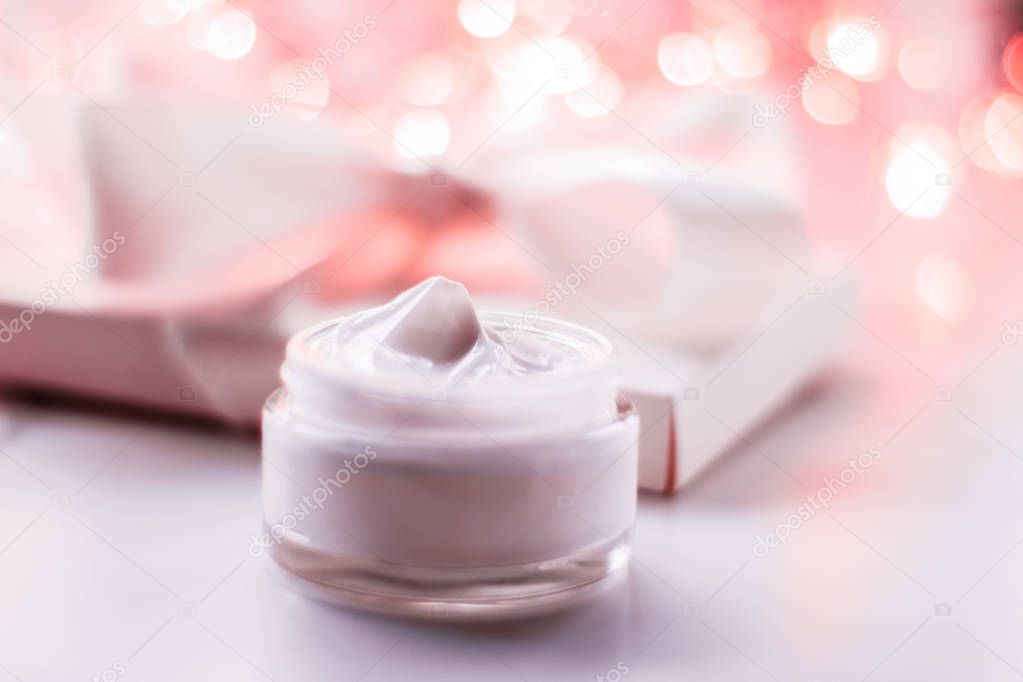 Facial cream moisturizer jar on holiday glitter background, mois