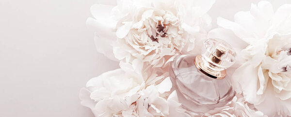 Fragrance bottle as luxury perfume product on background of peony flowers, parfum ad and beauty branding