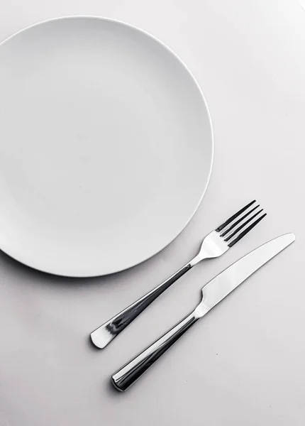 Placa vazia e talheres como mockup definido no fundo branco, utensílios de mesa superior para decoração de mesa de chef e marca de menu — Fotografia de Stock