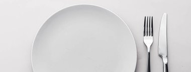 Boş tabak ve çatal bıçak seti beyaz arka planda, şef masa dekorasyonu ve menü markalaşması için en üst masa takımı