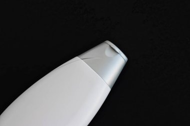 Siyah arkaplanda ürün modeli olarak boş etiket kozmetik kutu şişesi