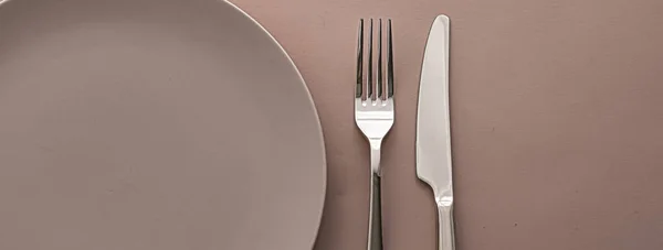 Prázdný talíř a příbory jako mosazná sada na hnědém pozadí, horní stolní nádobí pro šéfkuchaře stolní dekorace a značkování menu — Stock fotografie