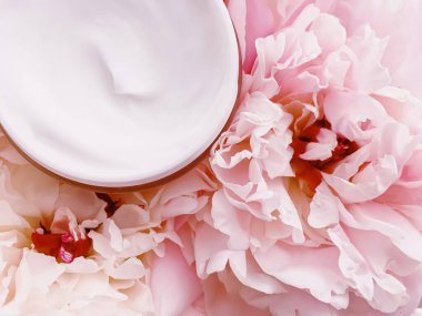 Çiçek arkaplanında yüz kremi nemlendiricisi. Lüks cilt bakım ürünleri, sağlık ve güzellik ürünleri.