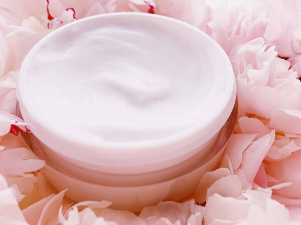Face cream moisturizer on floral background as luxury skincare cosmetics, healthcare and beauty product