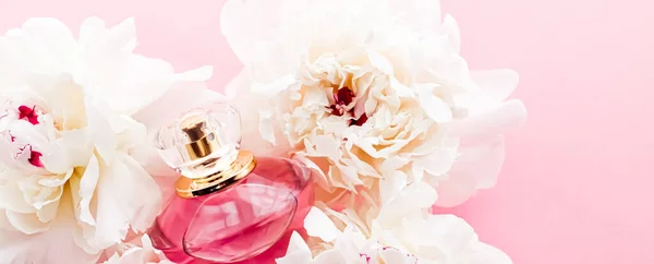 Luxurious fragrance bottle as chic perfume product on background of peony flowers, parfum ad and beauty branding