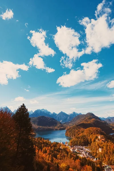 Beautiful nature of European Alps, landscape view of alpine mountains, lake and village in autumn season, travel and destination